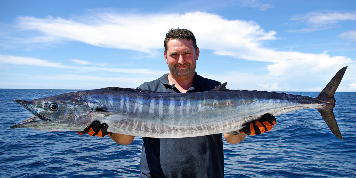 Fisherman with giant wahoo fish caught in the Indian sea near Zanzibar